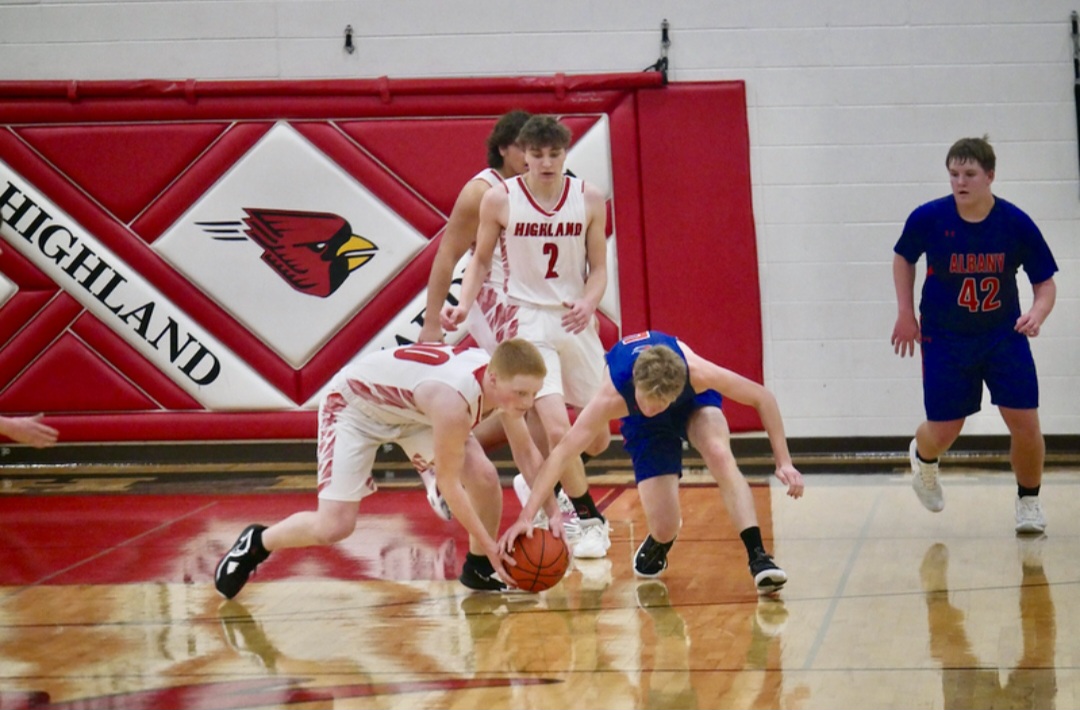 Ethan Lee fights for a loose ball on the ground.